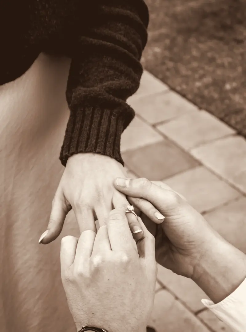 Chanel's hand with her engagement ring in Ivan's hands