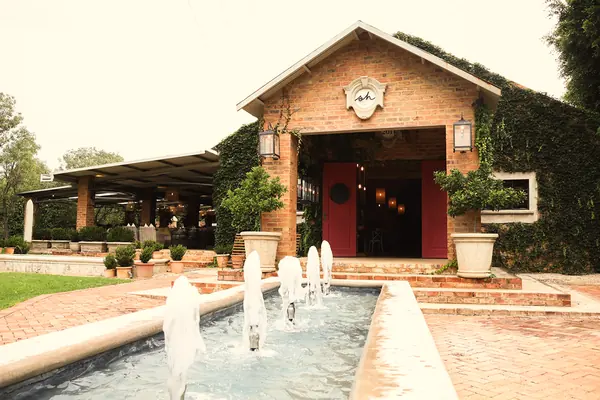 Stoorhuijs from outside: the brick entrance with red doors and fountains